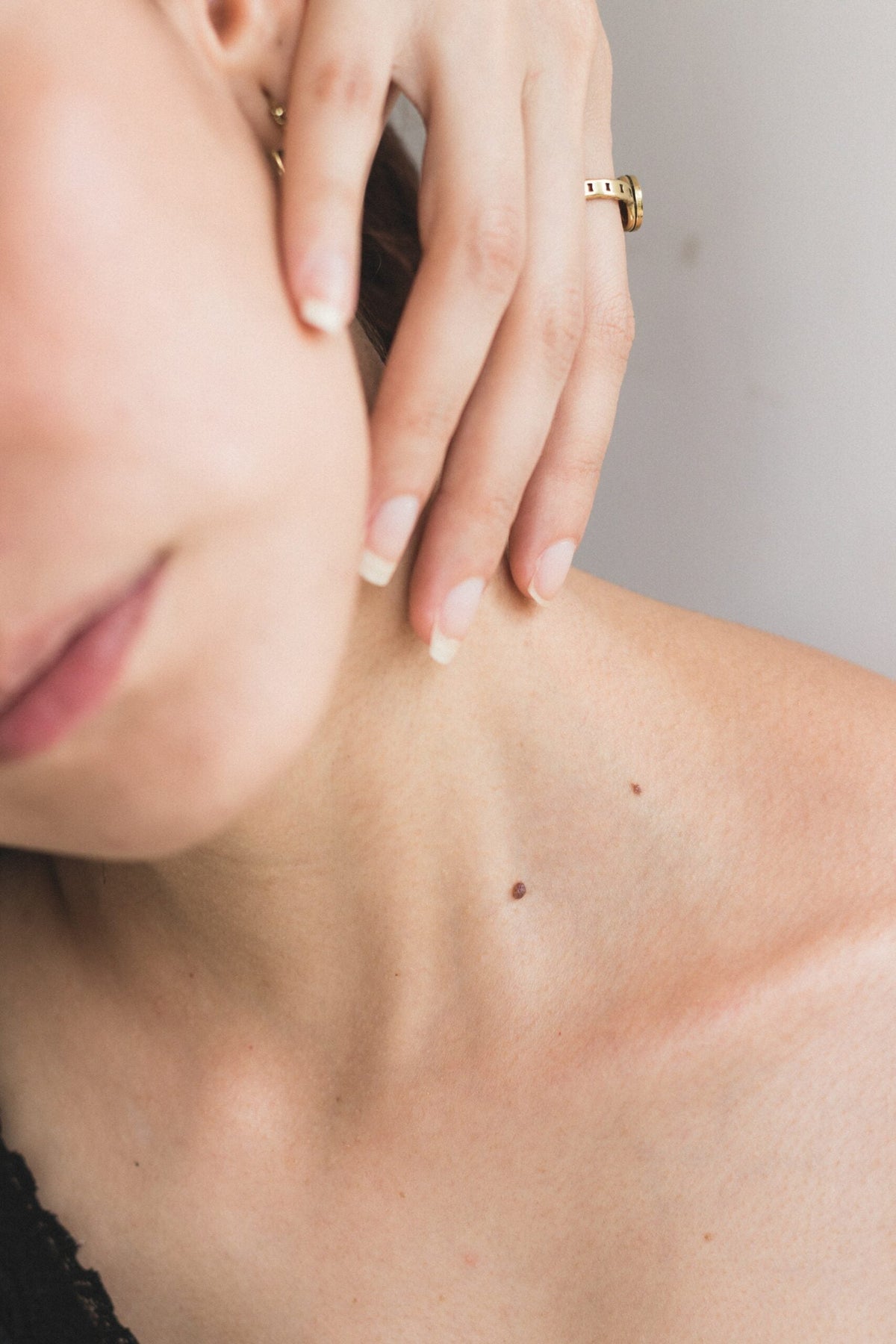 Woman touching her neck in a close-up portrait