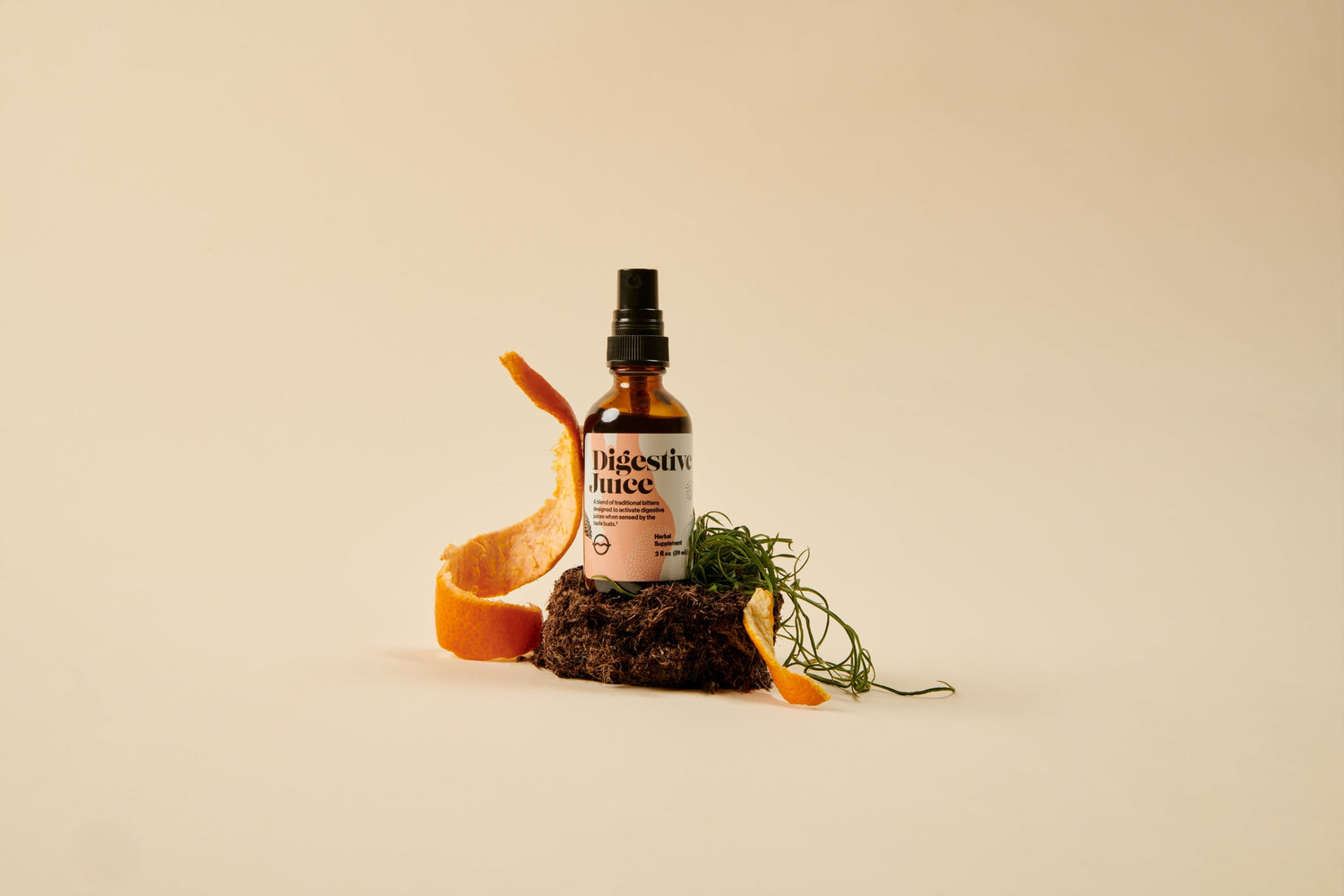 Front view of Digestive Juice spray bottle showcasing amber glass with orange peel and herbs on a beige background