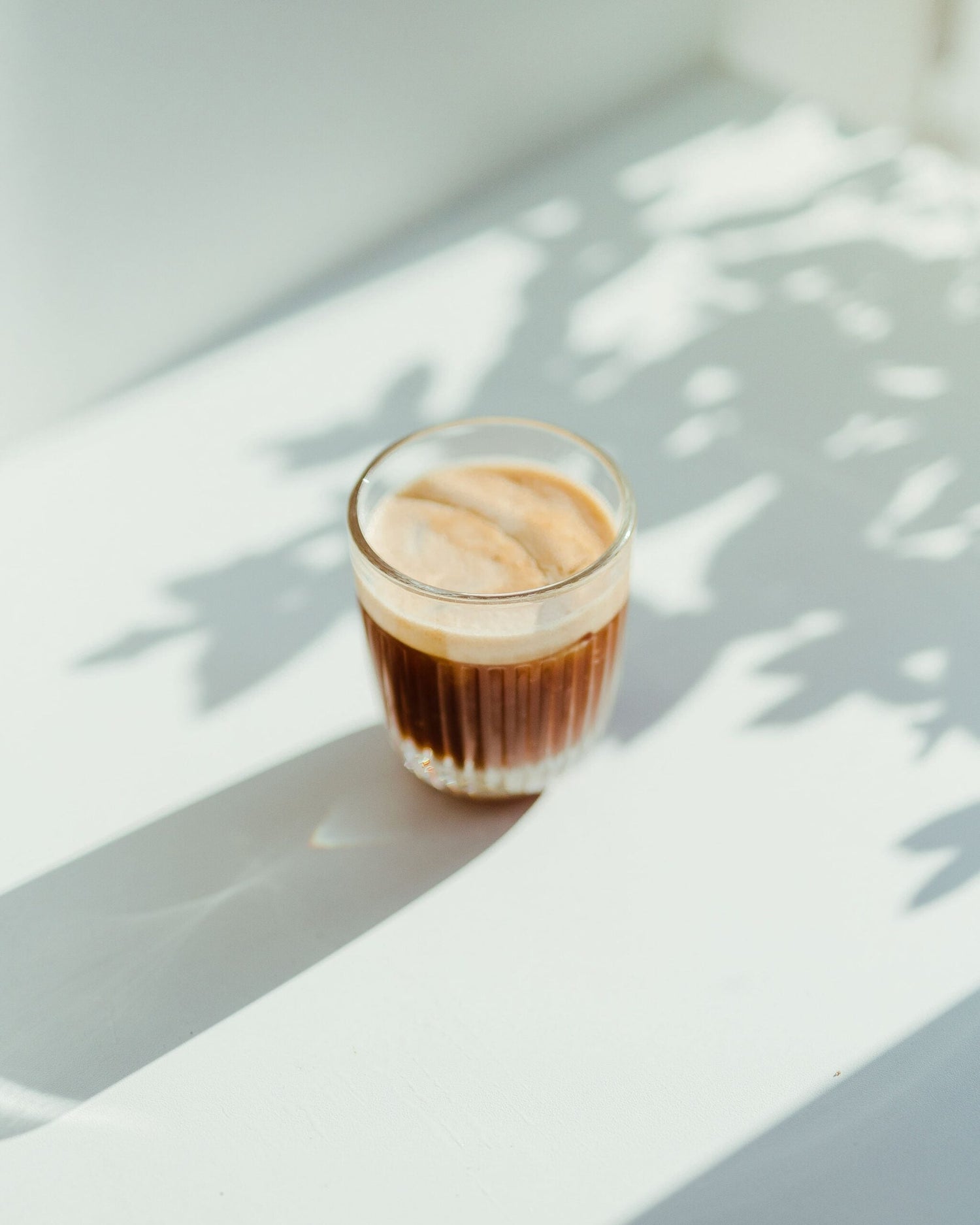 frothy cup of coffee on a white background