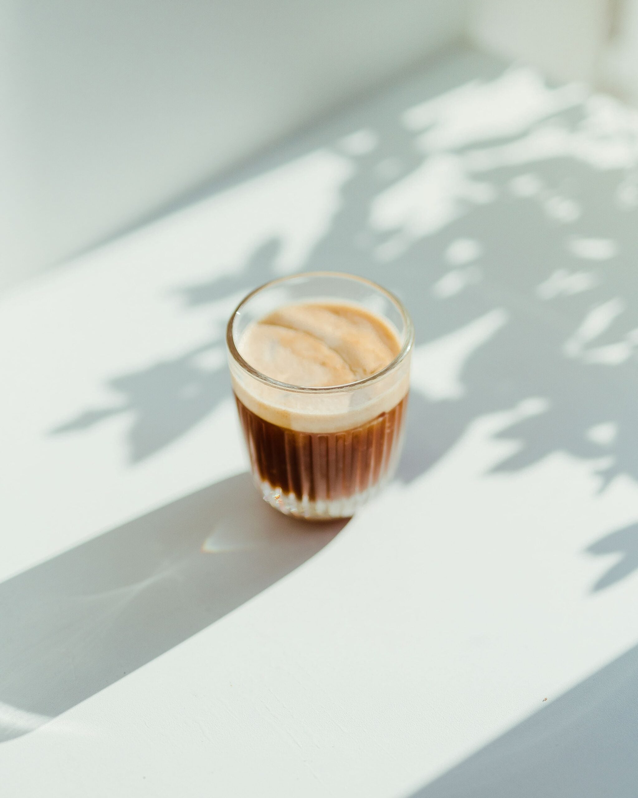 frothy cup of coffee on a white background
